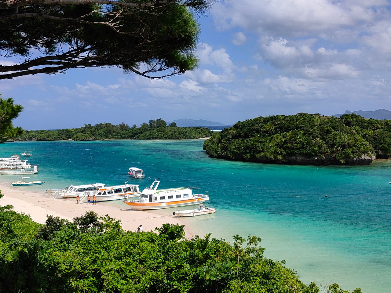 Explore the stunning beaches and turquoise waters of Ishigaki, Okinawa with scenic boat views.